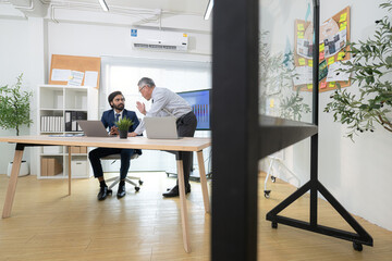 In a contemporary office, two senior executives with a mission to brainstorm and monitor the progress of a business project
