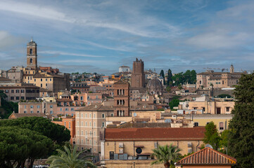 A scenic view over Rome highlighting its iconic dome architecture and urban structure, nestled against a backdrop of greenery