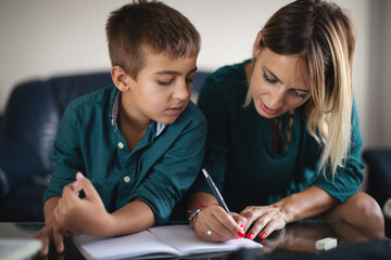 Mother and her son doing homework together
