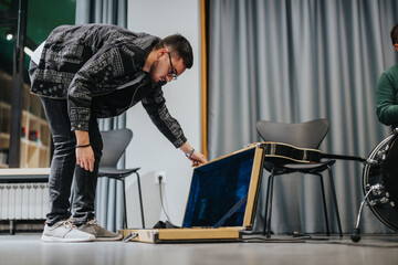 A musician interacts with their instrument case during a rehearsal session in a studio. The vibrant...
