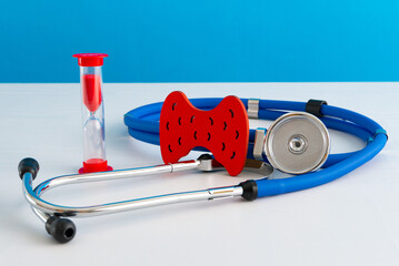 Anatomical model human thyroid gland closeup with hourglass and stethoscope