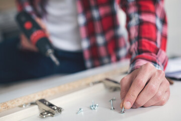 Young man making his own furniture at home