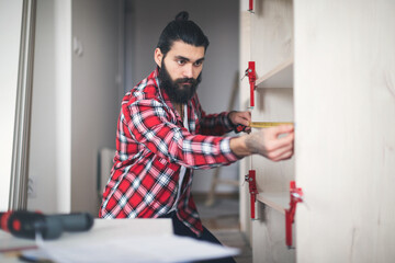 Young man making his own furniture at home