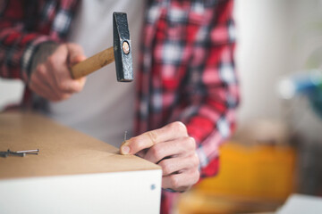 Young man making his own furniture at home