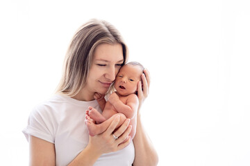 a mother with a newborn baby in her arms gently hugs and kisses him, a mother and a newborn baby in...