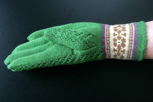 knitted gloves on a black background, Latvia