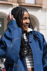 Young woman listening to music in urban setting