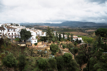 Obraz premium View of the Andulasian village of Ronda, Spain, famed for its old architecture and a bridge over a deep gorge. It is a rare cloudy day in southern Spain