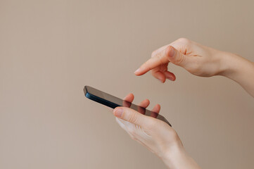 Woman Holds Smartphone and Presses on Screen, Close-Up Interaction Concept