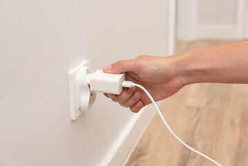 Man plug charger into smart socket
