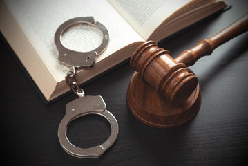 Handcuffs and wooden gavel. Law concept