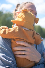 Caring dad embracing his small child during golden summer afternoon. Pure parental love and...