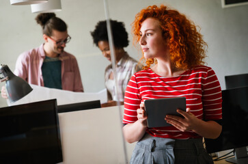 Group of business people and software developers working as a team in modern startup office