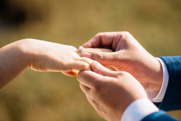 groom gives bride wedding ring