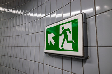 Green emergency exit sign with running man icon