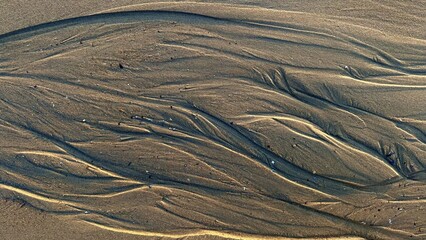 Earthy Brown Beach Sand Texture with Sandy Taupe Tidal Ripples, Selective Focus, Copy Space