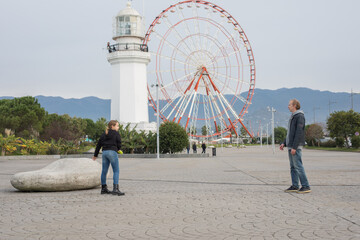Father and child playing flying disc and having fun outdoors. Happy family, sport and leisure activity concept