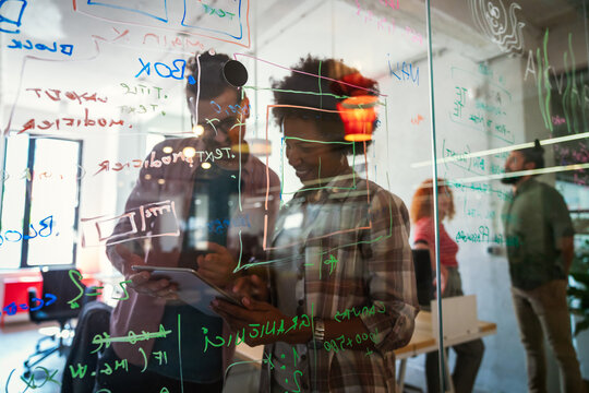Group of business people and software developers working as a team in modern startup office