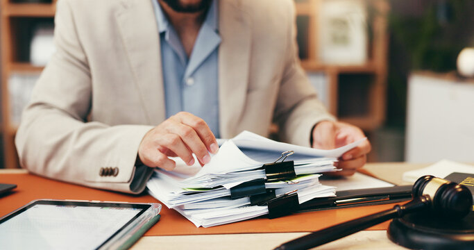Hands, judge and stack with documents at office for legal review, administration and investigation. Person, paperwork and overwhelmed with deadline, time management and gavel for law, justice or case