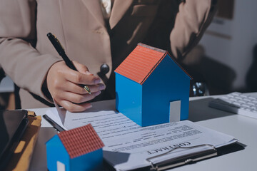 Female Real Estate Broker presenting and advised to .model home and building project detail in the...