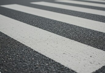 Fototapeta premium White striped zebra crossing on dark asphalt street. Road marking for pedestrian safety on urban city road. Pattern street transportation concept.