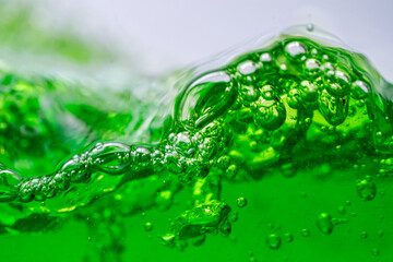 Water wave, close up of vibrant green liquid with bubbles, capturing dynamic movement and...
