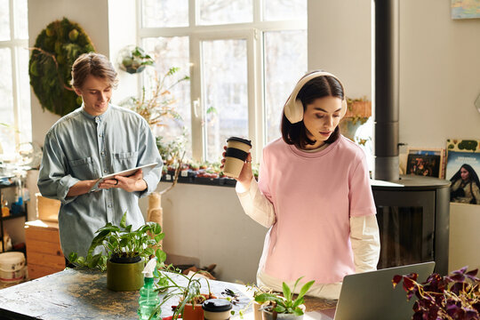 Two artists collaborate in a lively studio, surrounded by greenery and crafting unique projects