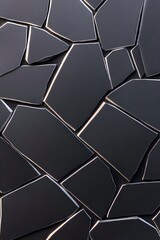 Dark gray, irregular polygon shapes form a textured, fragmented surface  Metallic highlights accentuate the seams