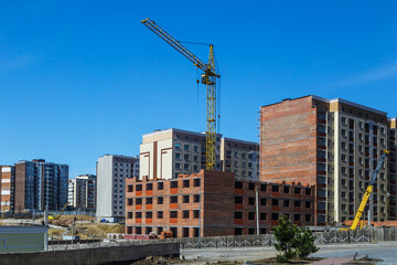 Extensive scaffolding providing platforms for work in progress on a new apartment block,Tall...