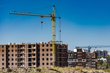 Extensive scaffolding providing platforms for work in progress on a new apartment block,Tall building under construction with scaffolds,Construction Site of New Building