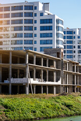 Extensive scaffolding providing platforms for work in progress on a new apartment block,Tall building under construction with scaffolds,Construction Site of New Building