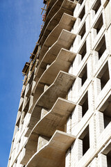 Extensive scaffolding providing platforms for work in progress on a new apartment block,Tall...