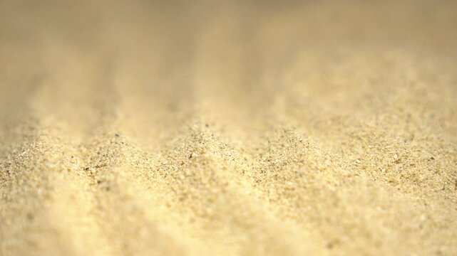 Background of beige beach sand with natural pattern, zoom in.