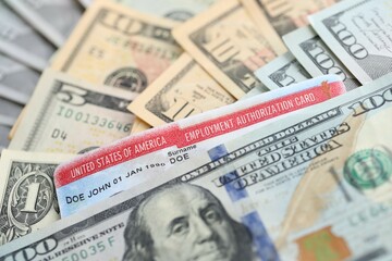 American US dollars money bills and employment authorization card close up. Immigration and naturalization
