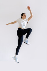 Woman performs high-intensity workout routine in bright indoor space
