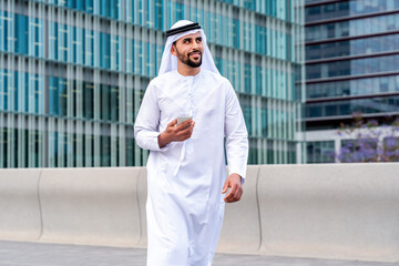 Arab middle-eastern man wearing emirati kandora traditional clothing in the city