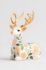 Porcelain deer figurine, white body with gold antlers and pastel rose floral design