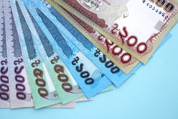 Obraz premium Bangladeshi taka money bills in big amount lies on teal color table close up