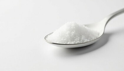 Spoonful of white sugar against white backdrop, macro, white sugar, still life