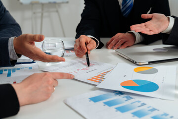 Business Meeting with Data Presentation and Document Discussion