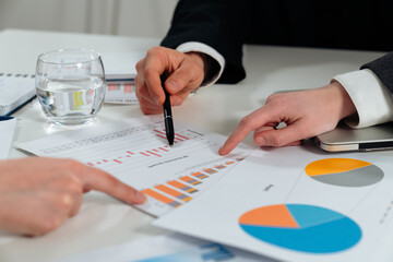 Collaborative Business Meeting Analyzing Financial Reports Together