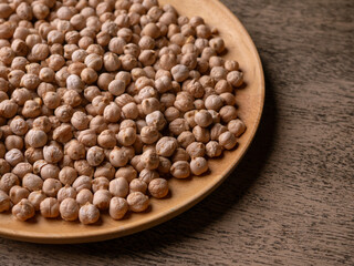 Raw Chickpeas on a rustic wooden table. Dry chickpea background close up. Chickpea legumes seed background.