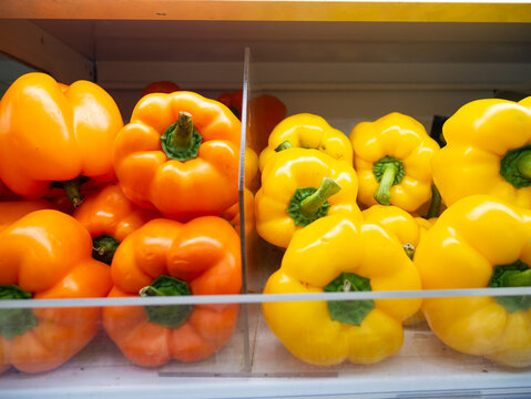 Orange Bell peppers (capsicum) on supermarket shelf. - Powered by Adobe