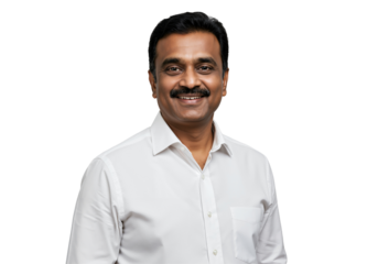 A confident and friendly middle-aged Indian man with a mustache smiles warmly while wearing a crisp white shirt against a plain black studio background.