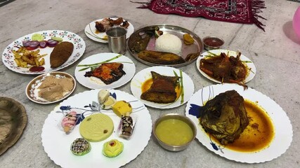 Bengali rice ceremony thali which includes fish, mutton, Sandesh, crab, misti doi.