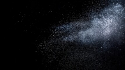 Obraz premium Fine dust particles suspended in still black space creating dreamy atmospheric scatter fragmented