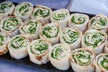 Buffet food for party decorated with fresh plants. Sandwiches with cheese and ham on table.  Catering buffet food indoor in luxury restaurant with meat and vegetables. Buffet table with delicacies