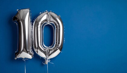 Fototapeta premium Banner with number 10 balloons on dark blue background with copy space.
