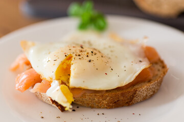 Diet breakfast with cooked egg and lightly salted red fish