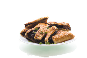 Crispy puff pastries with mushroom filling and sesame seeds, isolated on white background